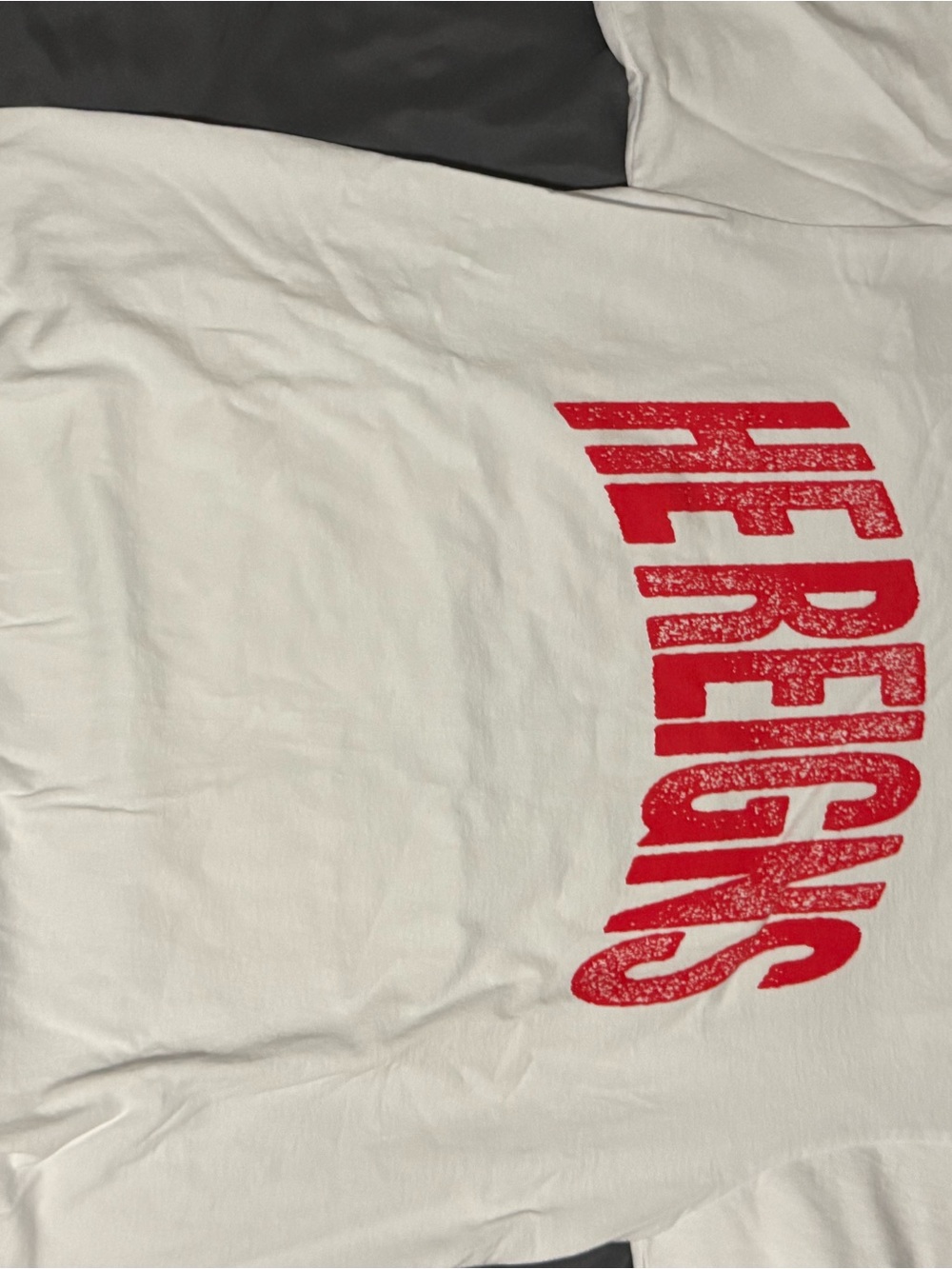 White Short Sleeve Tee with Red 'HE REIGNS' Graphic Christian Shirt